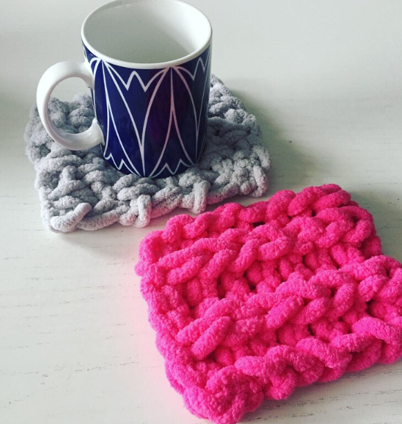 A mug and coasters on a table

Description automatically generated